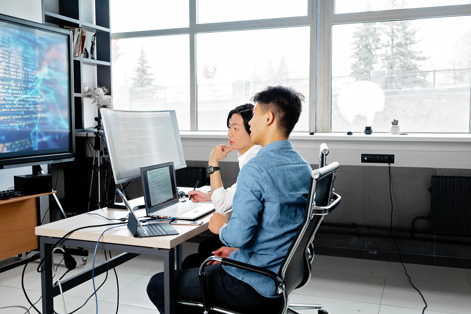 Two engineers reviewing legacy application code together